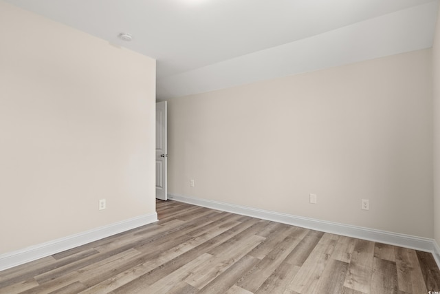 spare room with light wood-type flooring and baseboards