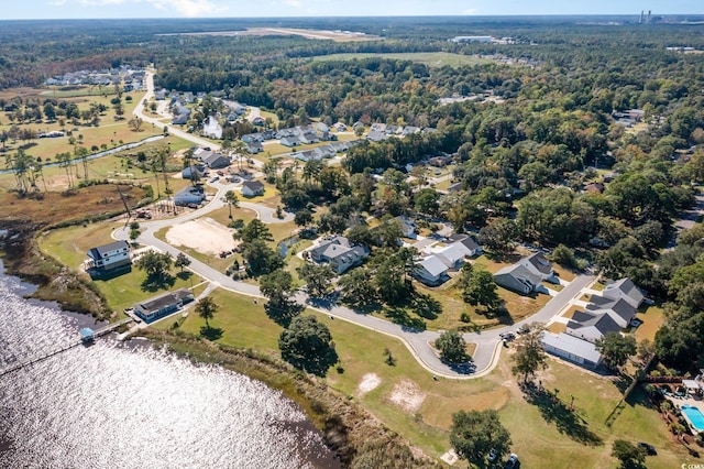 aerial view featuring a forest view and a water view