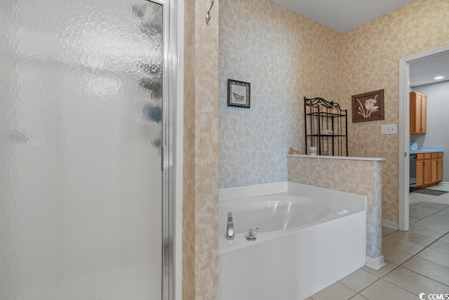 bathroom with a shower stall, tile patterned floors, a garden tub, and wallpapered walls