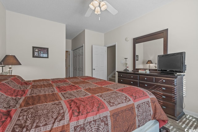 bedroom with a ceiling fan, a closet, and carpet flooring