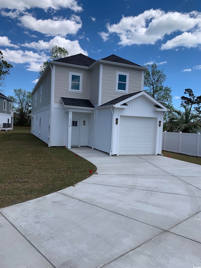 view of front property featuring a front yard, central AC, and a garage