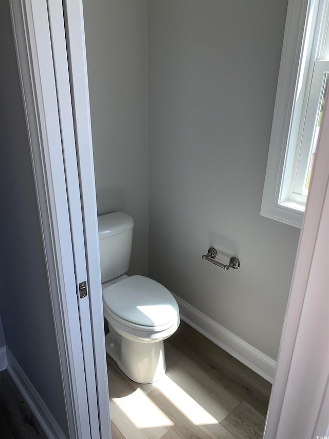 bathroom with toilet and hardwood / wood-style flooring