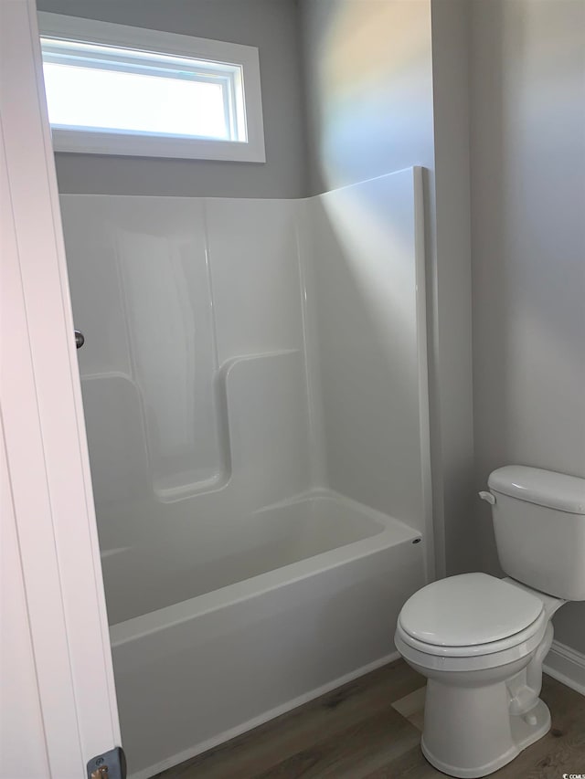 bathroom featuring shower / bath combination, toilet, and wood-type flooring