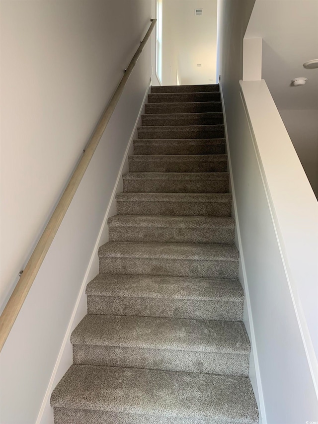 stairs featuring carpet