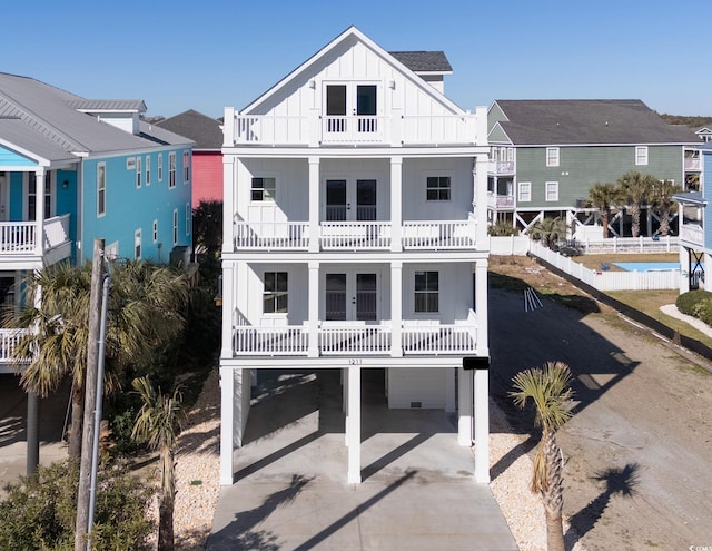 view of front of property with a carport and a balcony