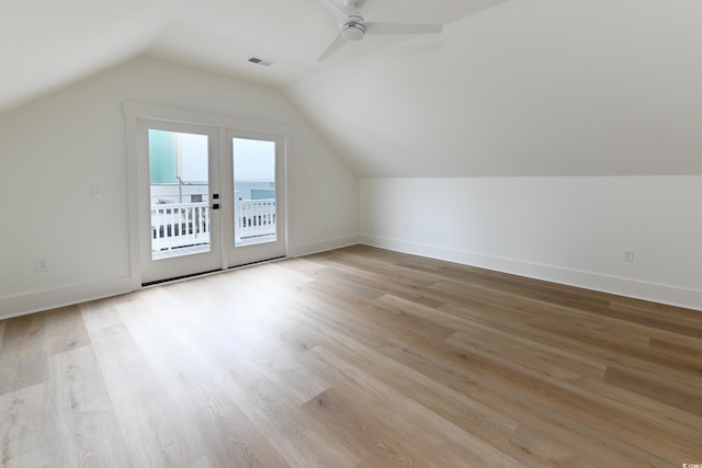 additional living space featuring ceiling fan, vaulted ceiling, and light wood-type flooring