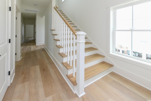 stairway with hardwood / wood-style floors