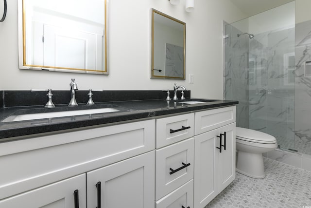 bathroom with a shower with door, vanity, and toilet