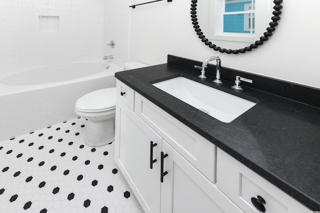 full bathroom featuring vanity, toilet, and tiled shower / bath combo