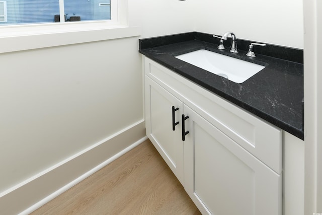 bathroom featuring vanity and hardwood / wood-style floors