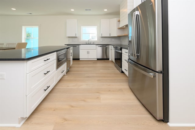 kitchen with open shelves, appliances with stainless steel finishes, white cabinetry, dark countertops, and backsplash