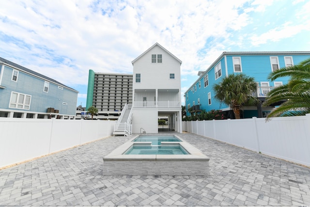 view of swimming pool featuring a patio area and an in ground hot tub