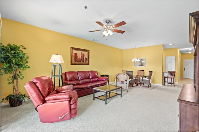 carpeted living room with ceiling fan with notable chandelier