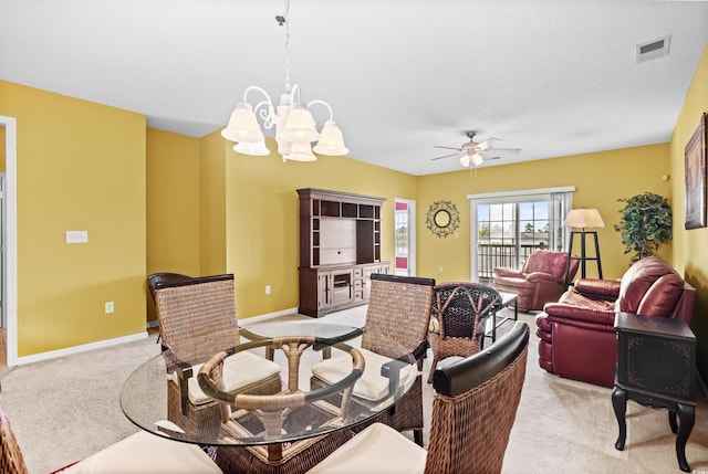 interior space featuring ceiling fan with notable chandelier and light carpet