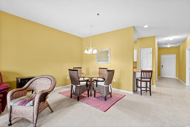 carpeted dining space featuring a notable chandelier