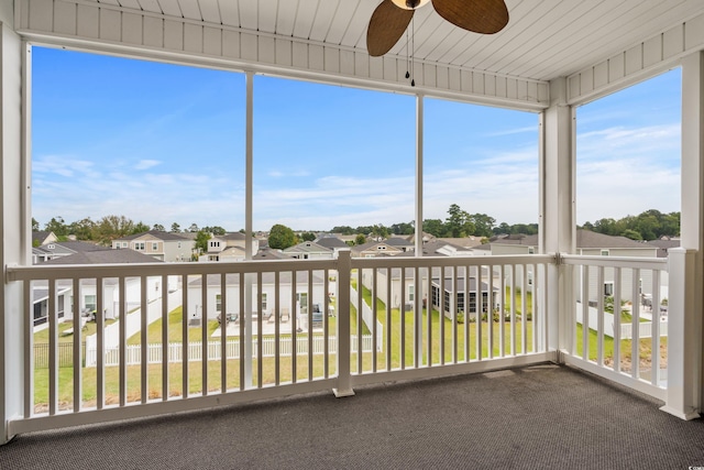 unfurnished sunroom with a wealth of natural light and ceiling fan