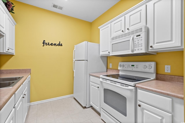 kitchen featuring white appliances, white cabinetry, and sink