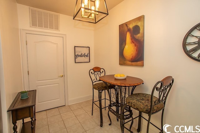 dining space featuring a notable chandelier and light tile flooring