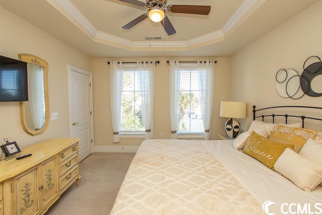 bedroom with light carpet, a raised ceiling, ornamental molding, and ceiling fan