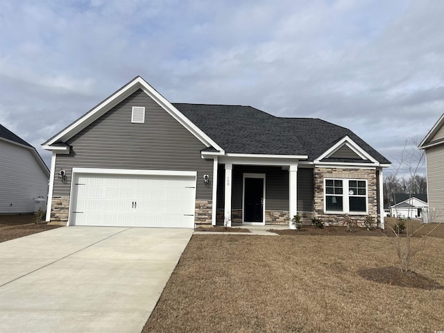 craftsman-style home featuring a garage and a front lawn