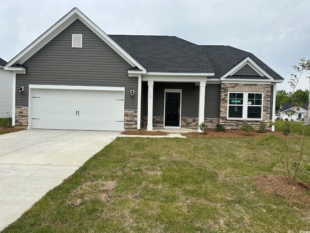 craftsman inspired home featuring a front lawn and a garage