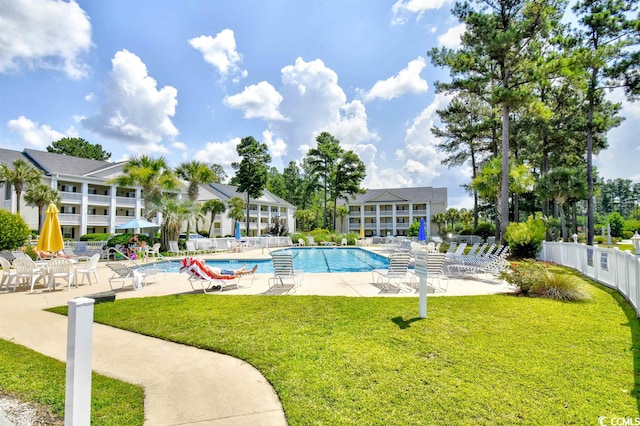 view of swimming pool featuring a lawn and a patio area