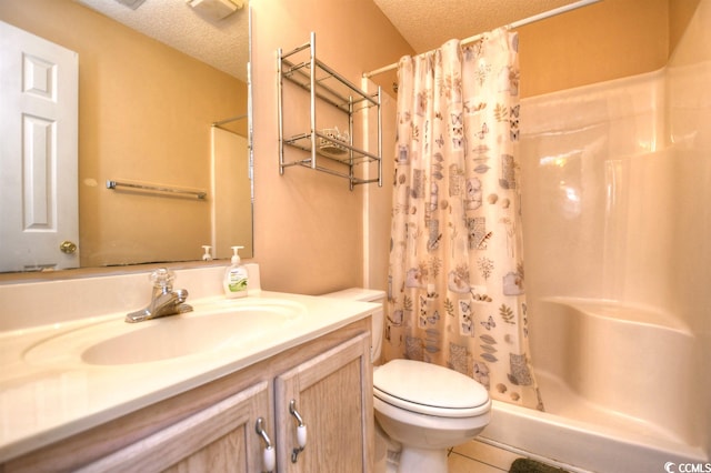 bathroom with toilet, curtained shower, tile flooring, a textured ceiling, and vanity