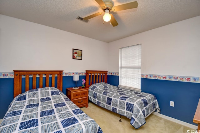 carpeted bedroom with a textured ceiling and ceiling fan