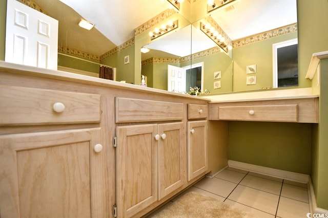 bathroom with lofted ceiling, vanity, and tile flooring