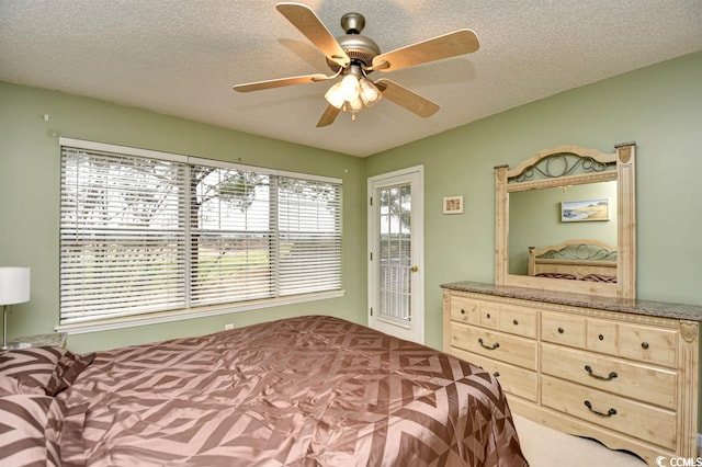 bedroom with ceiling fan and a textured ceiling