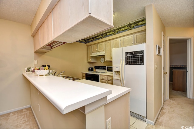 kitchen with light brown cabinets, kitchen peninsula, a textured ceiling, white appliances, and sink