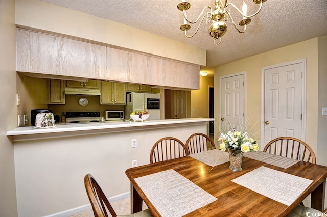 dining area with a textured ceiling, carpet floors, and a chandelier