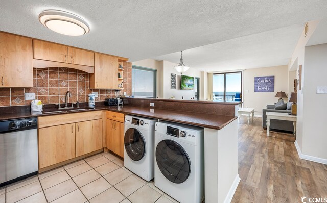 kitchen featuring kitchen peninsula, tasteful backsplash, a textured ceiling, light hardwood / wood-style flooring, and dishwasher