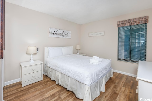 bedroom with hardwood / wood-style floors