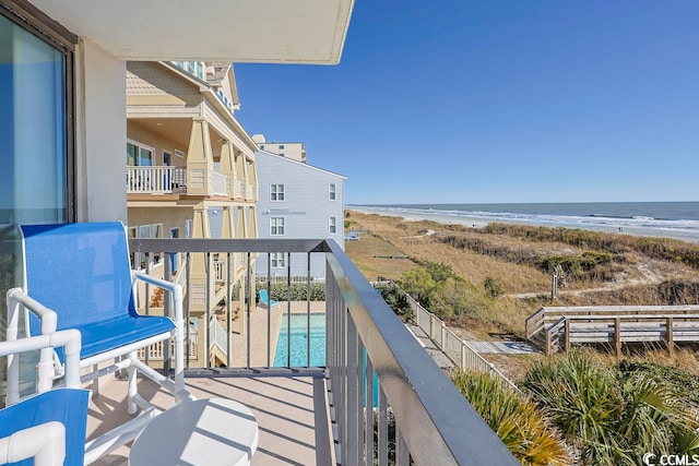 balcony with a beach view and a water view