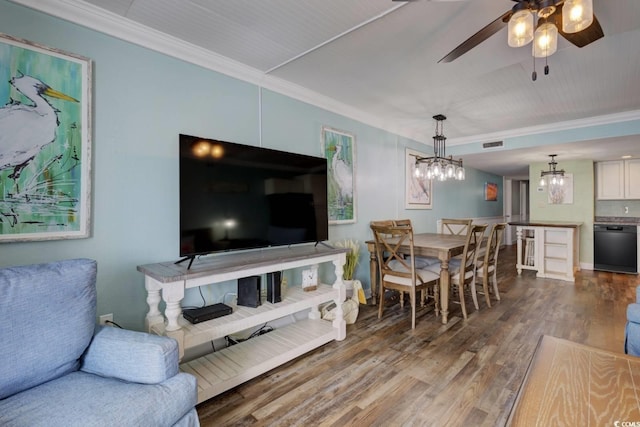 living room with hardwood / wood-style flooring, ceiling fan with notable chandelier, and crown molding