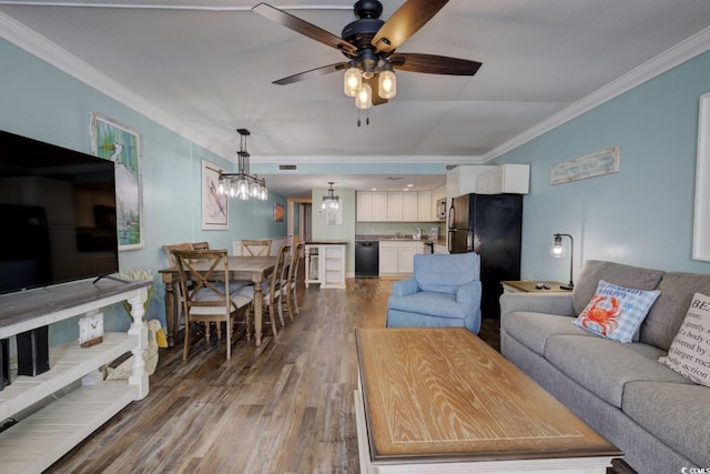 living room featuring ceiling fan with notable chandelier, dark hardwood / wood-style floors, and ornamental molding