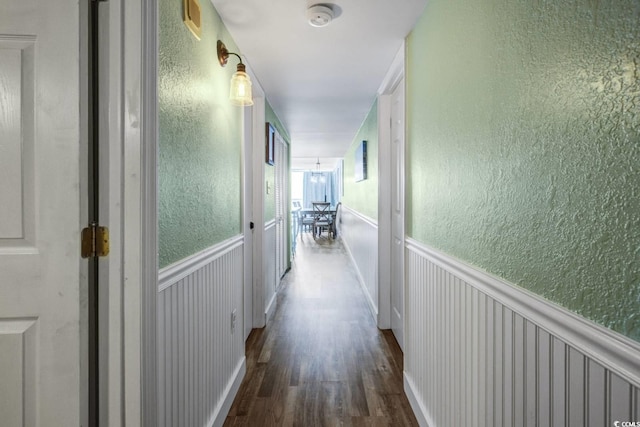 corridor with dark hardwood / wood-style flooring