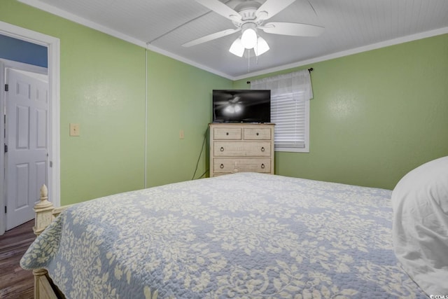 bedroom featuring ceiling fan, dark hardwood / wood-style flooring, and ornamental molding