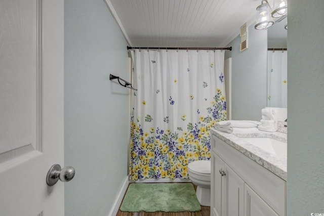 bathroom with vanity, crown molding, hardwood / wood-style floors, toilet, and curtained shower