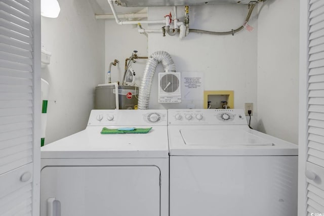 washroom with water heater and washer and clothes dryer