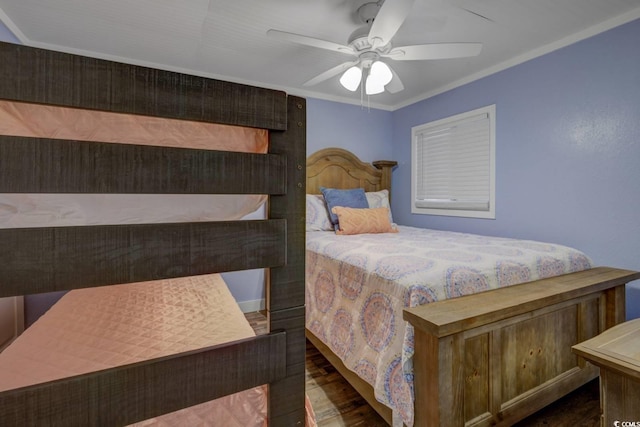 bedroom with dark wood-type flooring, ceiling fan, and ornamental molding