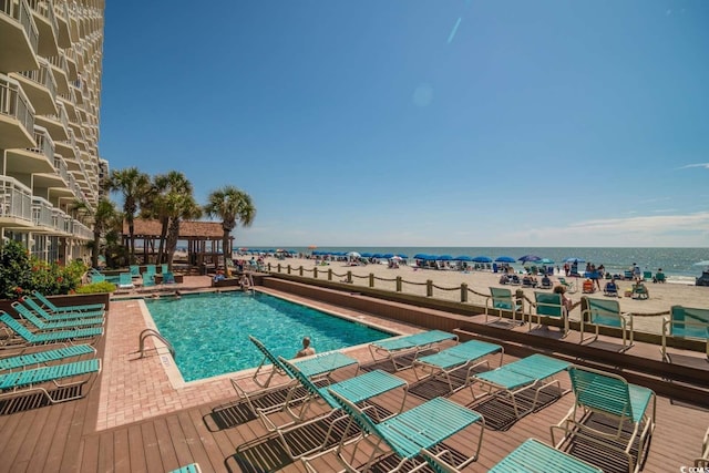 view of pool featuring a deck with water view