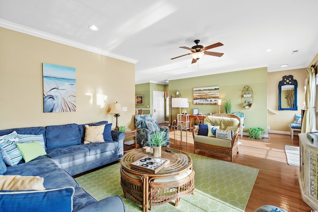 living room with ceiling fan, wood-type flooring, and ornamental molding