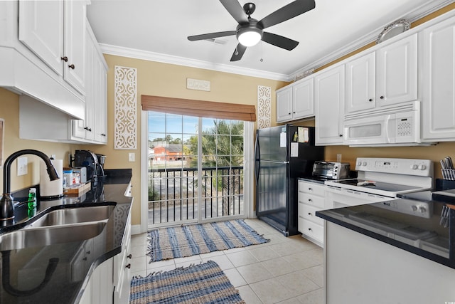 kitchen with white appliances, ornamental molding, and white cabinets