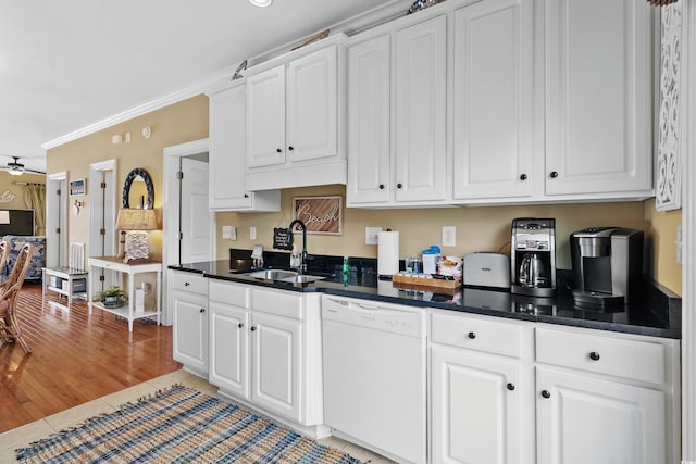 kitchen featuring light hardwood / wood-style floors, kitchen peninsula, ornamental molding, white appliances, and a chandelier