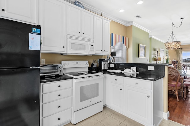 kitchen with light hardwood / wood-style floors, an inviting chandelier, kitchen peninsula, ornamental molding, and white appliances