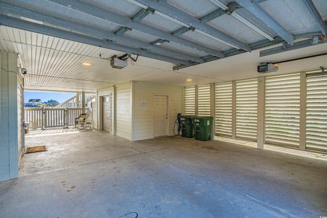 garage with a garage door opener and a carport