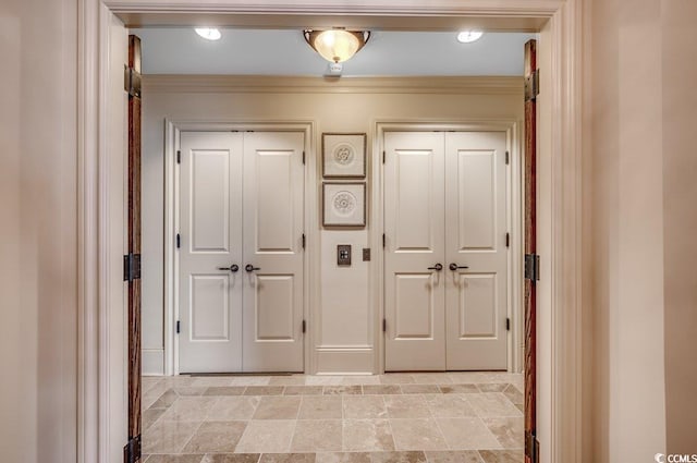 hallway featuring ornamental molding