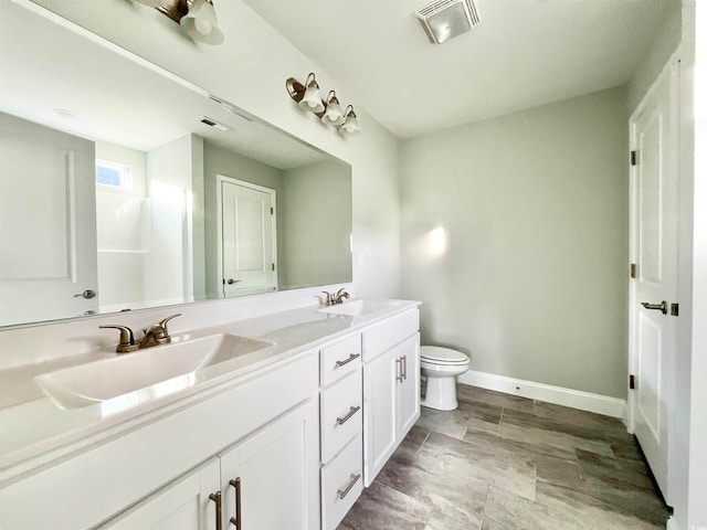 bathroom with toilet and vanity